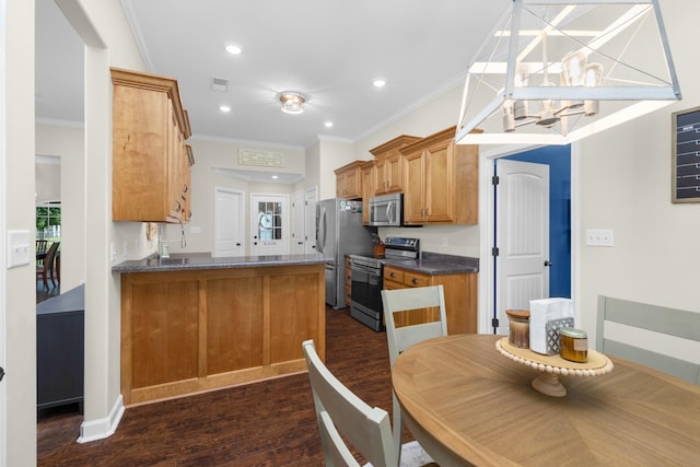 kitchen with crown molding, appliances with stainless steel finishes, dark countertops, brown cabinets, and dark wood-style floors