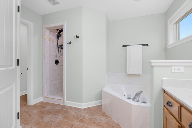 full bathroom with visible vents, a tile shower, a bath, and vanity