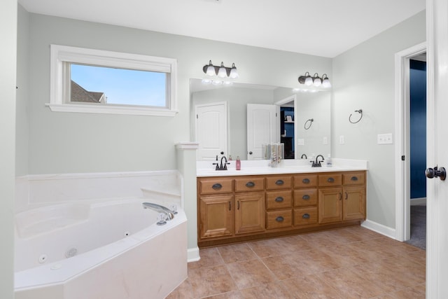 full bath with double vanity, tile patterned floors, a sink, and a jetted tub
