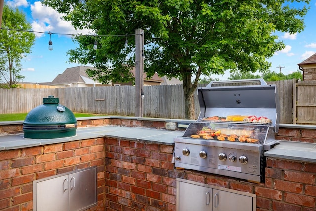 view of patio with area for grilling and a fenced backyard