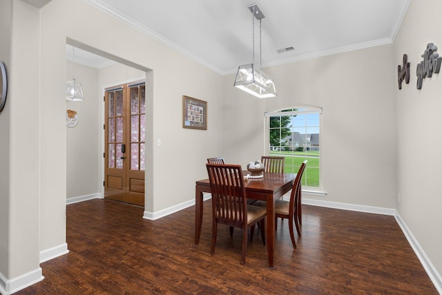 dining room featuring visible vents, baseboards, crown molding, and wood finished floors