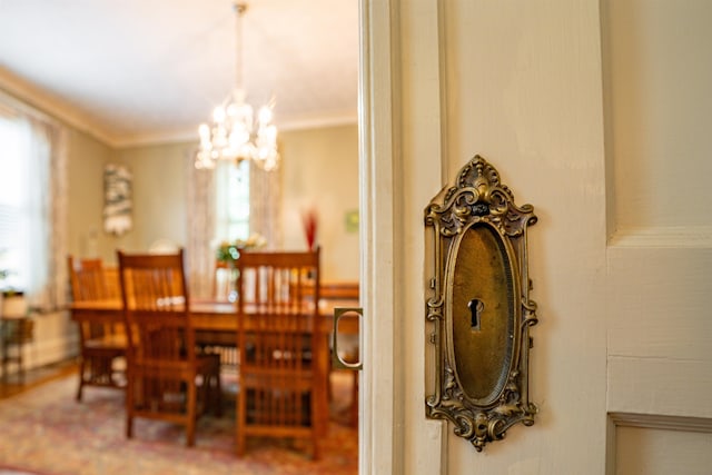 dining space with a chandelier and ornamental molding