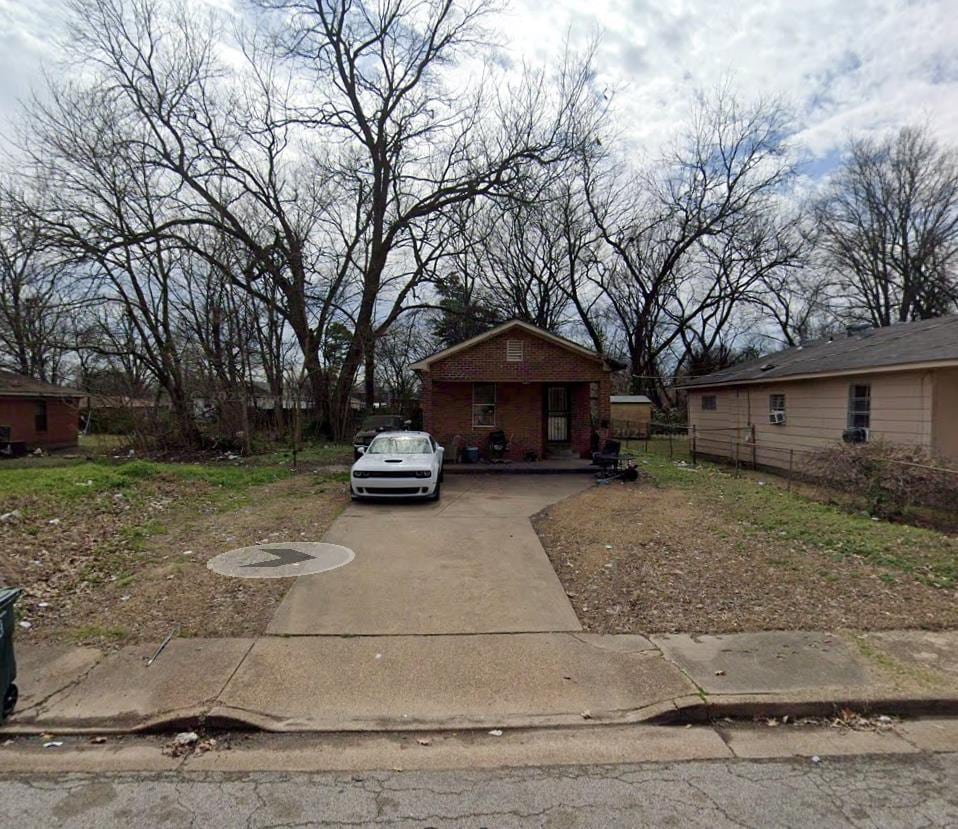 exterior space with fence and driveway