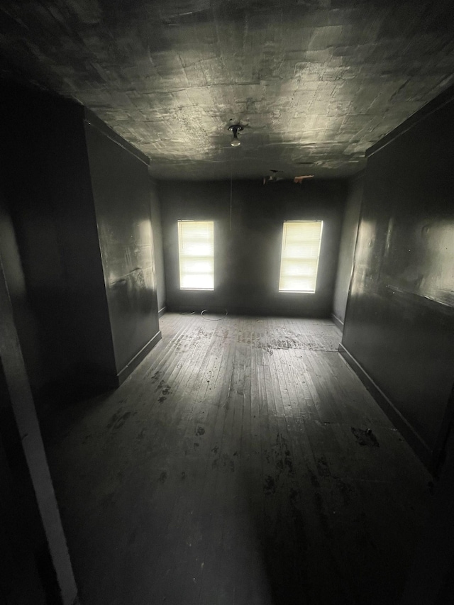 unfurnished room with wood-type flooring