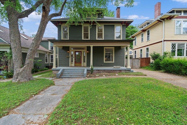 1682 Lawrence Ave, Memphis, TN 38112 - american foursquare style home featuring fence, a chimney, a porch, and a front lawn