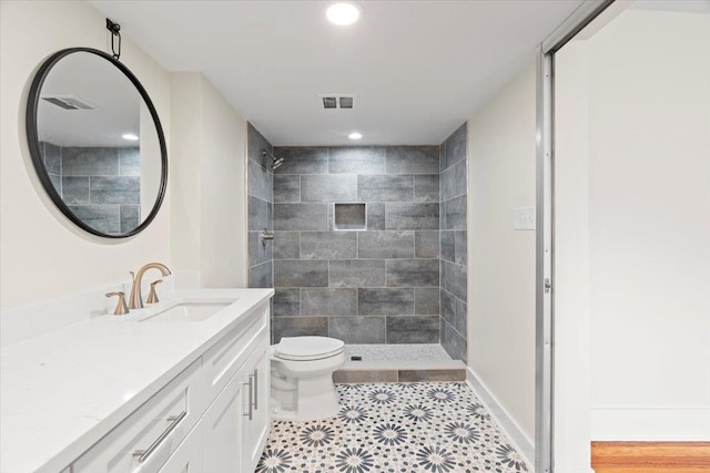 1682 Lawrence Ave, Memphis, TN 38112 - bathroom with vanity, a tile shower, toilet, and visible vents