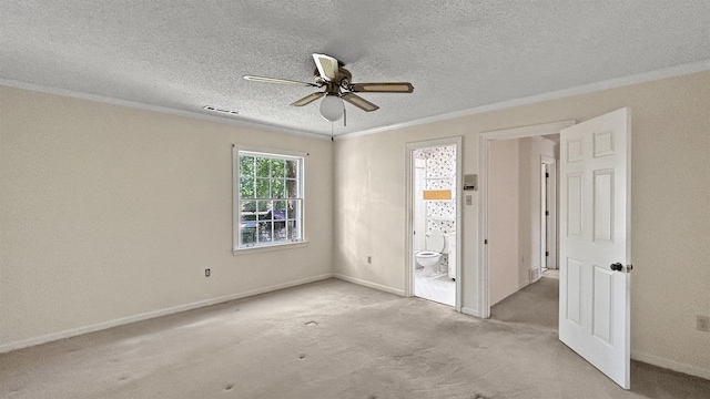 unfurnished bedroom with ornamental molding, a textured ceiling, visible vents, carpet floors, and baseboards