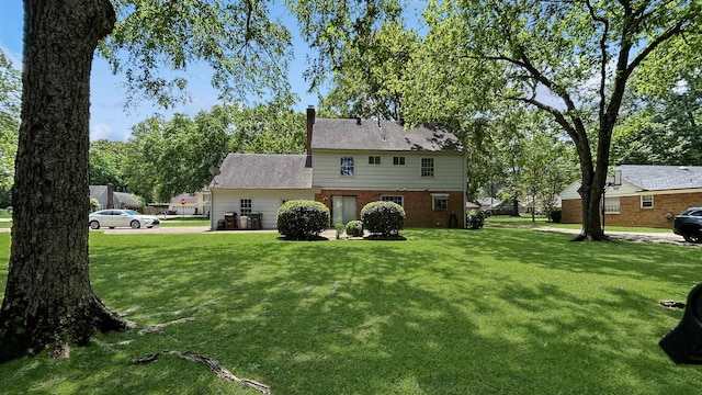 back of house with a yard