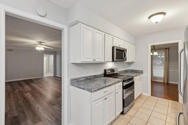 kitchen featuring ceiling fan, visible vents, dark countertops, white cabinets, and stainless steel appliances