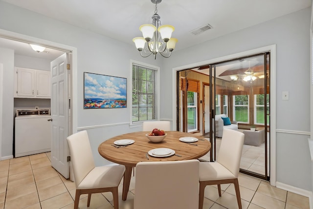 dining area featuring visible vents, an inviting chandelier, a healthy amount of sunlight, washer / clothes dryer, and light tile patterned floors