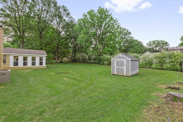 view of yard with an outdoor structure, a storage shed, and cooling unit