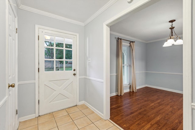 entryway with baseboards, ornamental molding, and light tile patterned floors