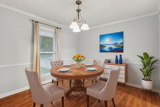 dining space with crown molding, light wood-style floors, baseboards, and a chandelier