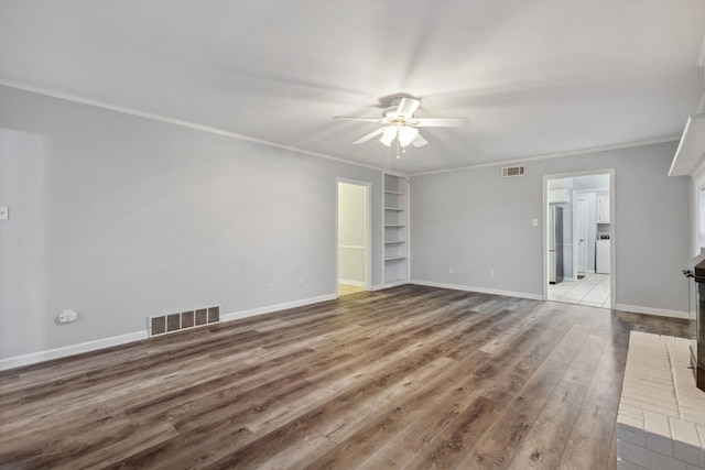 unfurnished living room featuring ornamental molding, a ceiling fan, wood finished floors, and visible vents