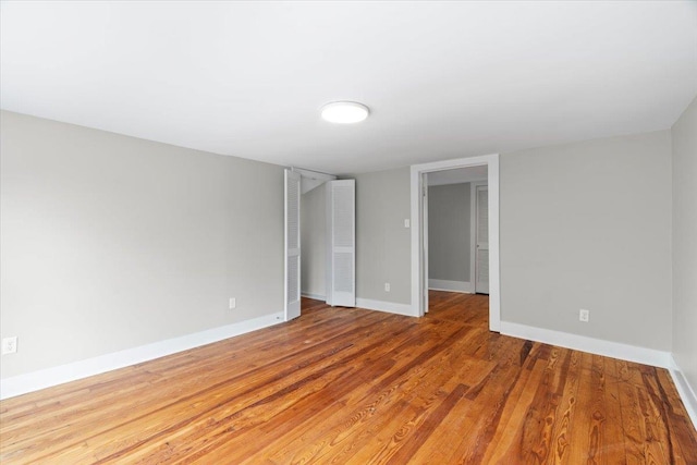 empty room featuring baseboards and wood finished floors