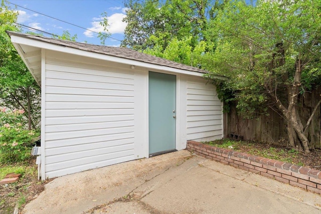 view of shed featuring fence