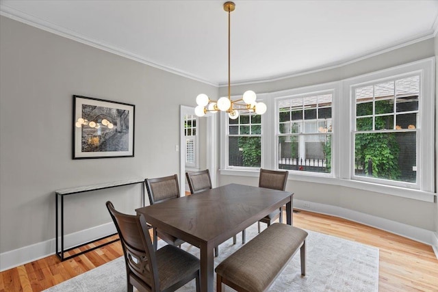 dining room with crown molding, plenty of natural light, and a notable chandelier