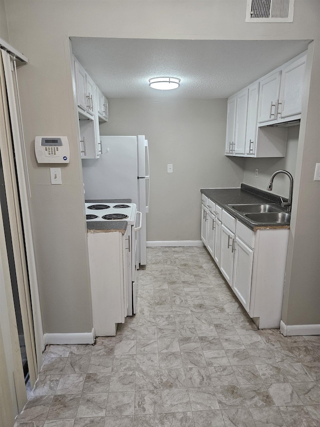 kitchen with visible vents, a sink, white cabinetry, and white range with electric stovetop