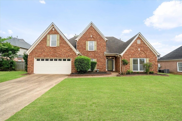 traditional-style home with brick siding, a garage, driveway, and a front lawn