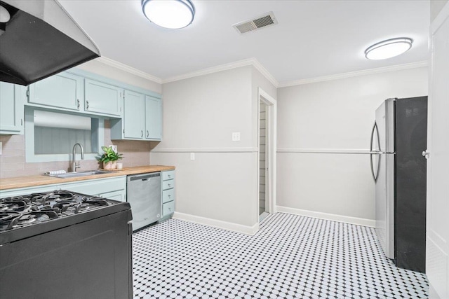 kitchen featuring visible vents, a sink, under cabinet range hood, ornamental molding, and stainless steel appliances
