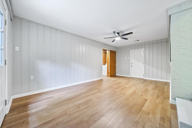 unfurnished room with baseboards, a ceiling fan, and light wood finished floors