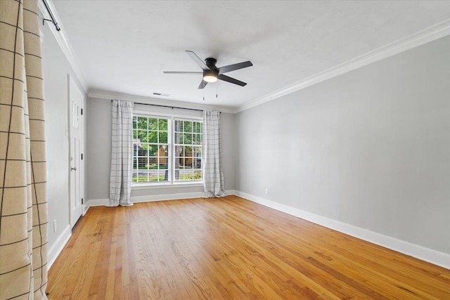 unfurnished room featuring a ceiling fan, baseboards, and ornamental molding