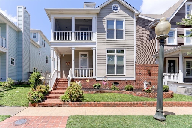 view of front of home with covered porch and a front yard