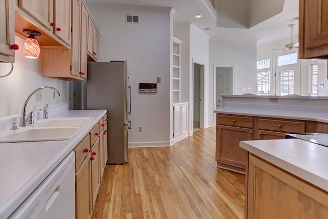 kitchen featuring visible vents, dishwasher, a sink, light countertops, and freestanding refrigerator