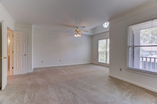 unfurnished room with light carpet, a ceiling fan, baseboards, visible vents, and ornamental molding