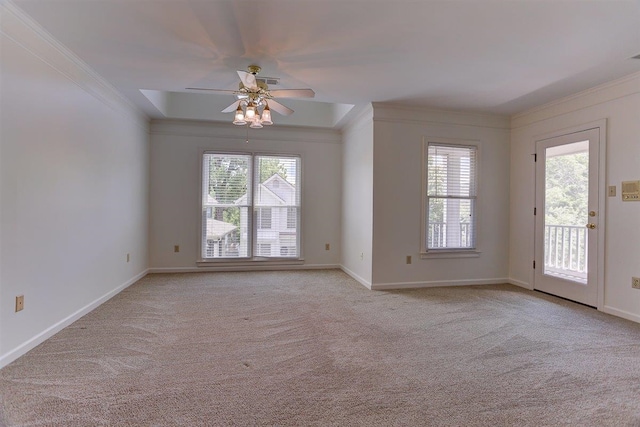 spare room with crown molding, carpet floors, and a healthy amount of sunlight