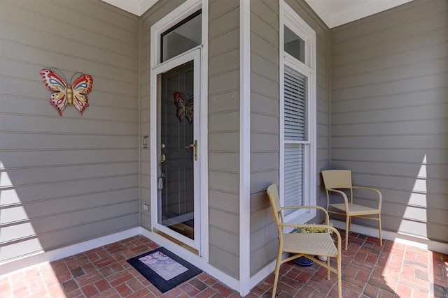 view of exterior entry with covered porch