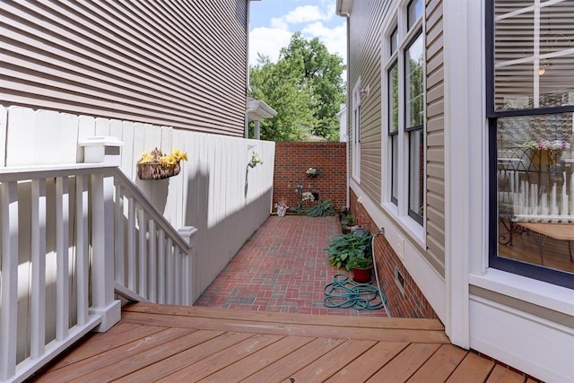deck featuring a patio area and fence