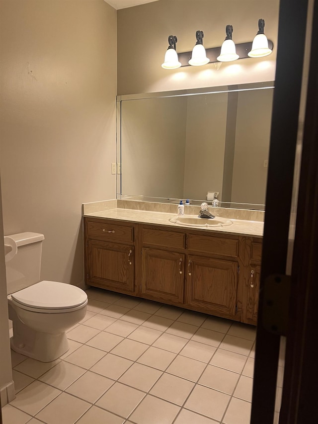 bathroom featuring toilet, tile patterned flooring, and vanity