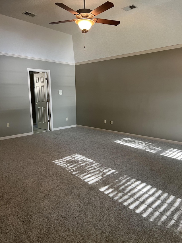 spare room featuring carpet floors, ceiling fan, visible vents, and baseboards