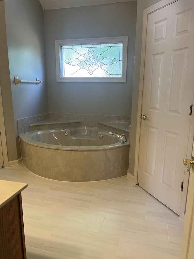 bathroom with a jetted tub and vanity