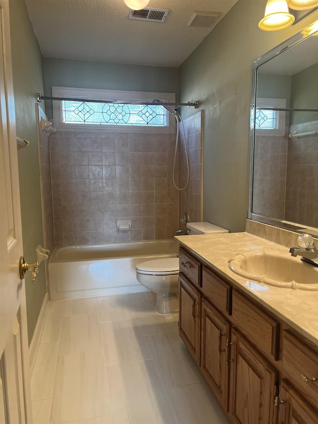 full bathroom featuring tub / shower combination, vanity, toilet, and visible vents