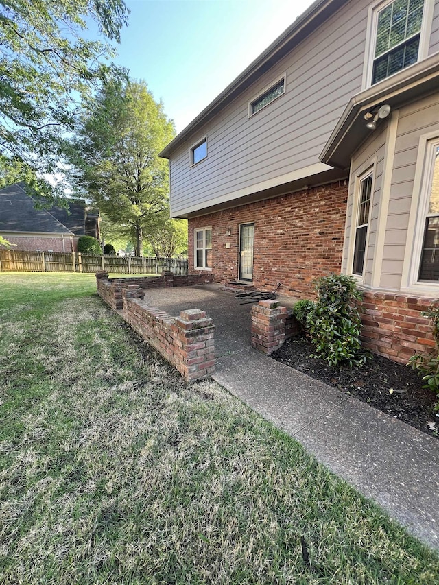 view of yard featuring fence and a patio