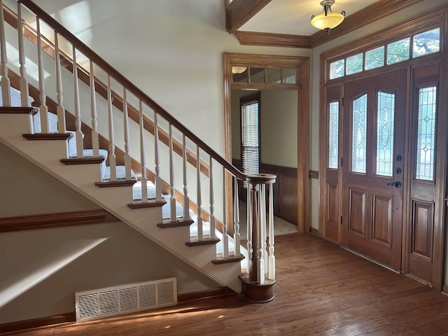 entrance foyer featuring stairway, hardwood / wood-style floors, and visible vents