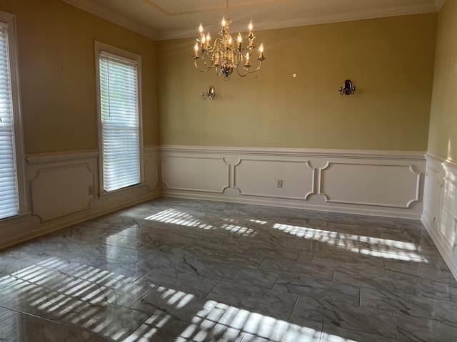 unfurnished dining area featuring an inviting chandelier, marble finish floor, a decorative wall, and a wainscoted wall