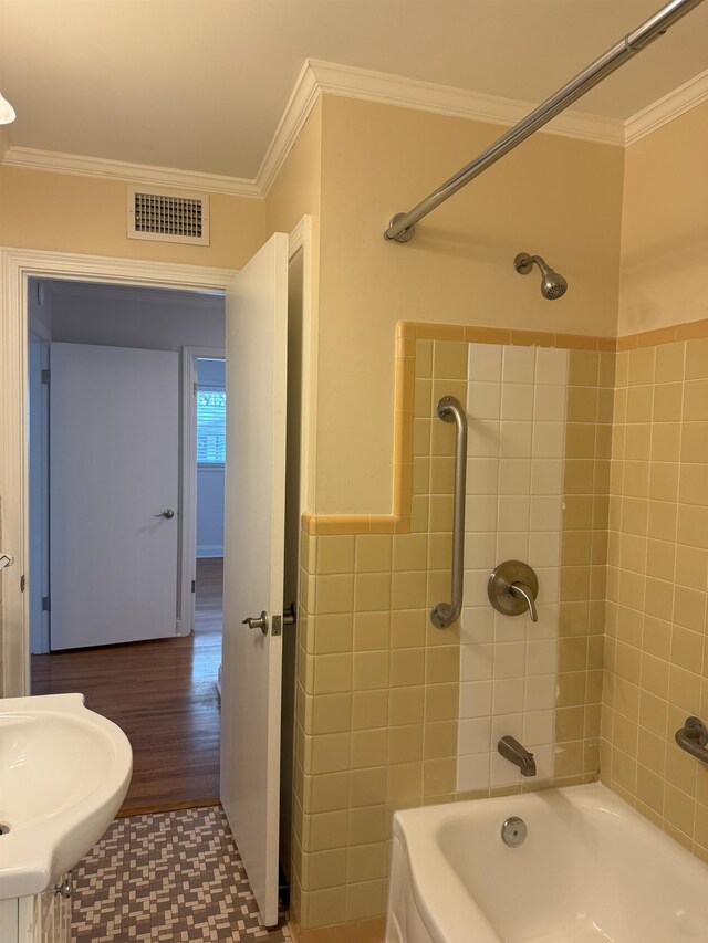 full bathroom with crown molding, a sink, shower / bath combination, and wood finished floors