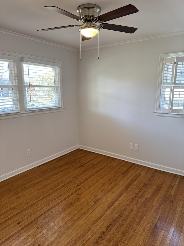 spare room featuring wood finished floors, ornamental molding, baseboards, and ceiling fan
