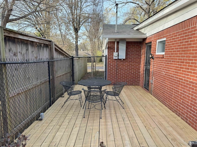 wooden deck with fence and outdoor dining area