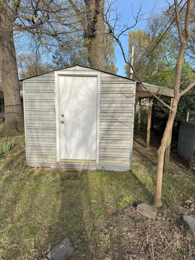view of shed featuring fence