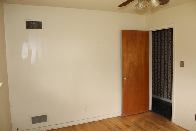 unfurnished bedroom featuring visible vents, ceiling fan, and wood finished floors