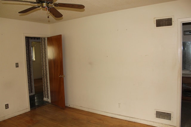 unfurnished bedroom with wood finished floors and visible vents