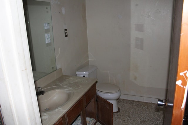 bathroom with toilet, tile patterned floors, and vanity