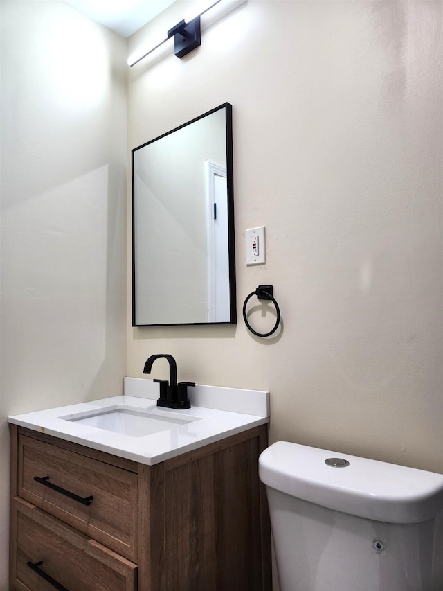 half bathroom with toilet and vanity