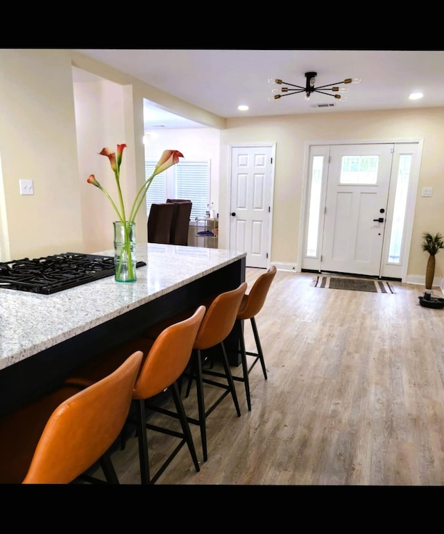 dining space with baseboards, recessed lighting, and light wood-type flooring