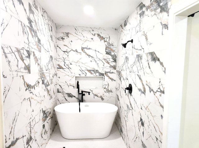 full bathroom with a freestanding bath and tile walls