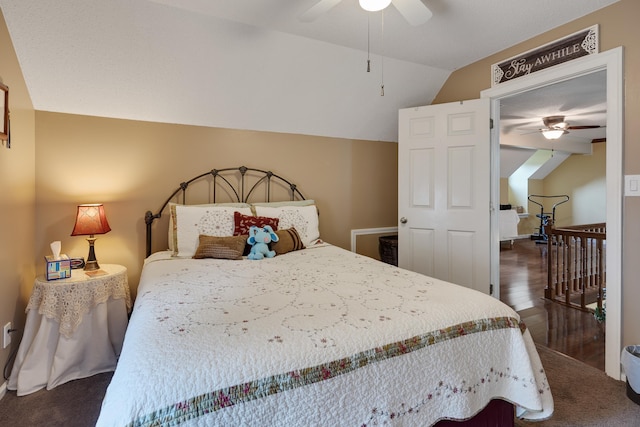 bedroom featuring wood finished floors, lofted ceiling, and ceiling fan